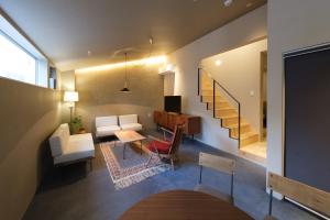 a living room with a couch and a table at Kamome Jyuku in Takamatsu