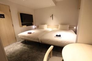 Postel nebo postele na pokoji v ubytování GEN HOTEL KAMAKURA