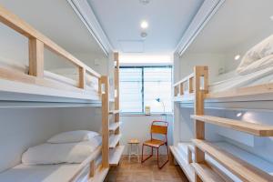 Rúm í herbergi á plat hostel keikyu haneda home