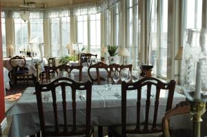 a dining room table with chairs and tables at Hotel Kullaberg - Sweden Hotels in Mölle