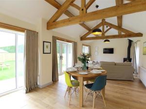 a living room with a wooden table and chairs at Park Bothy in Wyck Rissington