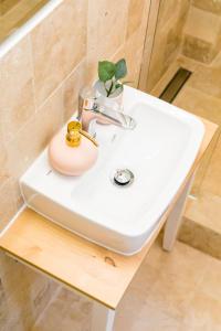 a bathroom sink with a plant on top of it at CATCHY DREAMS Spacious & Homey Apartment in Bucharest