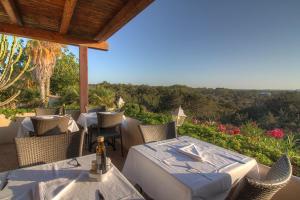 a table and chairs on a patio with a view at Hotel Club Sunway Punta Prima in Es Pujols