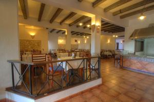 a large room with a restaurant with tables and chairs at Hotel Club Sunway Punta Prima in Es Pujols