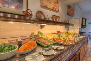 a buffet line with many different types of food at Hotel Club Sunway Punta Prima in Es Pujols