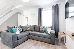 a living room with a couch and a table at The Place to Yourself - Swansea City in Swansea