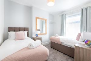 a bedroom with two beds and a window at The Place to Yourself - Swansea City in Swansea