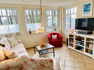 a living room with a couch and a tv at Neue Villa Ernst - Ferienwohnung 3 in Bansin