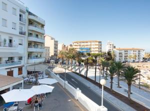 a street in a city with palm trees and buildings at La Cala Beach Deluxe Apartments in L'Ametlla de Mar