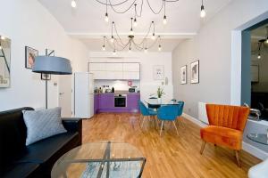 a living room with a couch and a table at Mulberry Flat 2 - Two bedroom 1st floor by City Living London in London