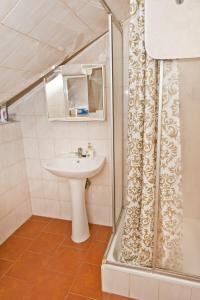 a bathroom with a sink and a shower curtain at Penzion pod svahem in Železná Ruda