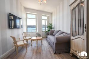 a living room with a couch and a table at Romantic Benaco Salò in Salò