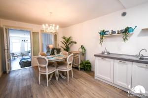 a kitchen and dining room with a table and chairs at Romantic Benaco Salò in Salò