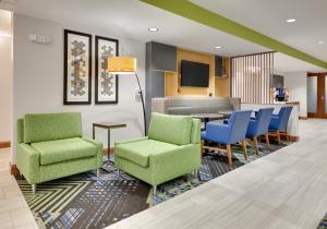 - une salle d'attente avec deux chaises et une table dans l'établissement Holiday Inn Express & Suites Mitchell, an IHG Hotel, à Mitchell