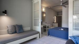 a small room with a bed and a desk at Aeolos Beach Resort in Gastourion