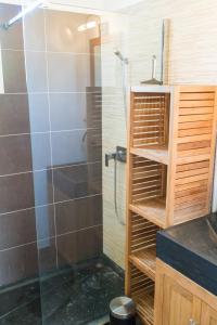 a bathroom with a shower with a glass door at Villa Vaunage Piscine Chauffée in Langlade