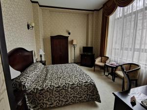 Кровать или кровати в номере Hotel Carol
