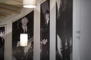 a room with pictures of musicians on the walls at Hard Days Night Hotel in Liverpool