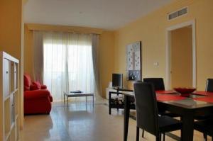 a living room with a table and a red couch at Apartamento con WiFi al lado de la playa in Marbella