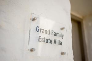 a sign that reads grand family estate villa on a wall at Stagones Luxury Villas in Ambelas