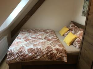 a small bed in a small room with a bedsheet at Apartmány Rychtaříkovi in Černý Dŭl +31 photos