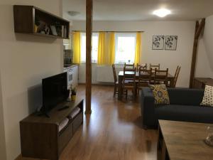 a living room with a couch and a table at Apartmány Rychtaříkovi in Černý Dŭl