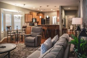 a living room with a couch and a kitchen at Thousand Hills Golf Resort in Branson