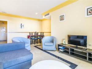 a living room with a couch and a tv at Apartamento 328 in Marbella