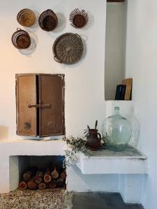 a room with a fireplace with a glass vase on the wall at Villa Kana - Mediterranean holiday home in Sali