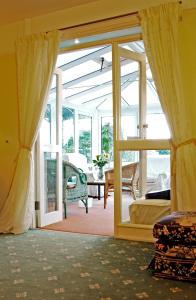 a living room with a door open to a patio at The Long Range in Budleigh Salterton