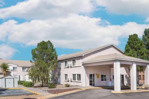 a large white building with a parking lot at Super 8 by Wyndham Socorro in Socorro