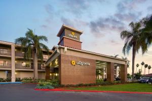 a large building with a clock on the front of it at La Quinta by Wyndham Orange County Airport in Santa Ana