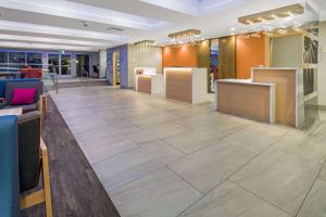 a lobby of a store with a tile floor at La Quinta by Wyndham Orange County Airport in Santa Ana
