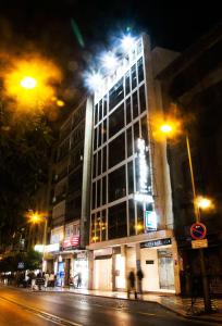 a building on a city street at night at Hotel Universal in Granada