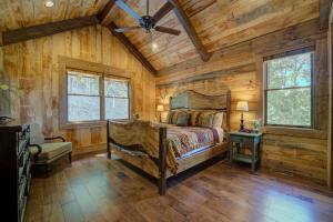 a bedroom with a bed and a ceiling fan at Serenity Cove in Blue Ridge