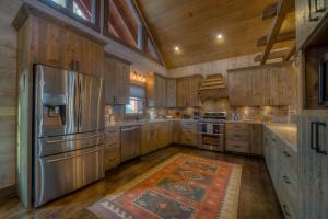 a kitchen with wooden cabinets and a stainless steel refrigerator at Sunrock View in Blue Ridge