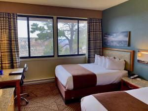 a hotel room with two beds and two windows at Kachina Lodge - Inside the Park in Grand Canyon Village +19 photos