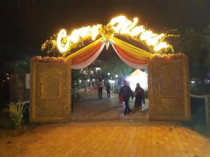 an archway with people walking through it at night at Cozywoods Hill Resort in Banastarim