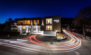 a building with lights on a street at night at ImPuls | aparts in Schladming