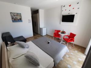 a bedroom with a bed and a table and chairs at Villa Šimović in Baška Voda