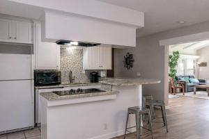 a kitchen with white cabinets and a counter top at Comanche Trail Guest House in Volente