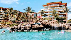 a group of people in the water at a resort at Honua Kai - Hokulani 509 - Ocean view from INSIDE! 2b/2b in Kaanapali