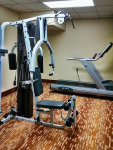 a gym with a treadmill and a tread machine at Chieftain Conference Center in Carrington +2 photos