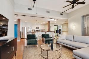 a living room with a couch and a table at LiivUP Warehouse Apartments in New Orleans