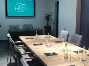 a conference room with a long table and chairs at Favor Sport Hotel in Kyiv