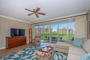 a living room with a couch and a flat screen tv at Honua Kai - Konea 642 - Ocean View from inside! 2b/2b in Kaanapali