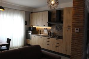 a kitchen with wooden cabinets and a couch in a room at Villa Martina in Desenzano del Garda