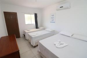 En eller flere senge i et værelse på Condomínio na beira mar
