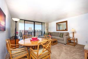 a living room with a table and a couch at Kaanapali Shores - 943 in Lahaina