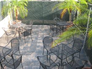 a group of tables and chairs on a patio at Suites Havre in Mexico City